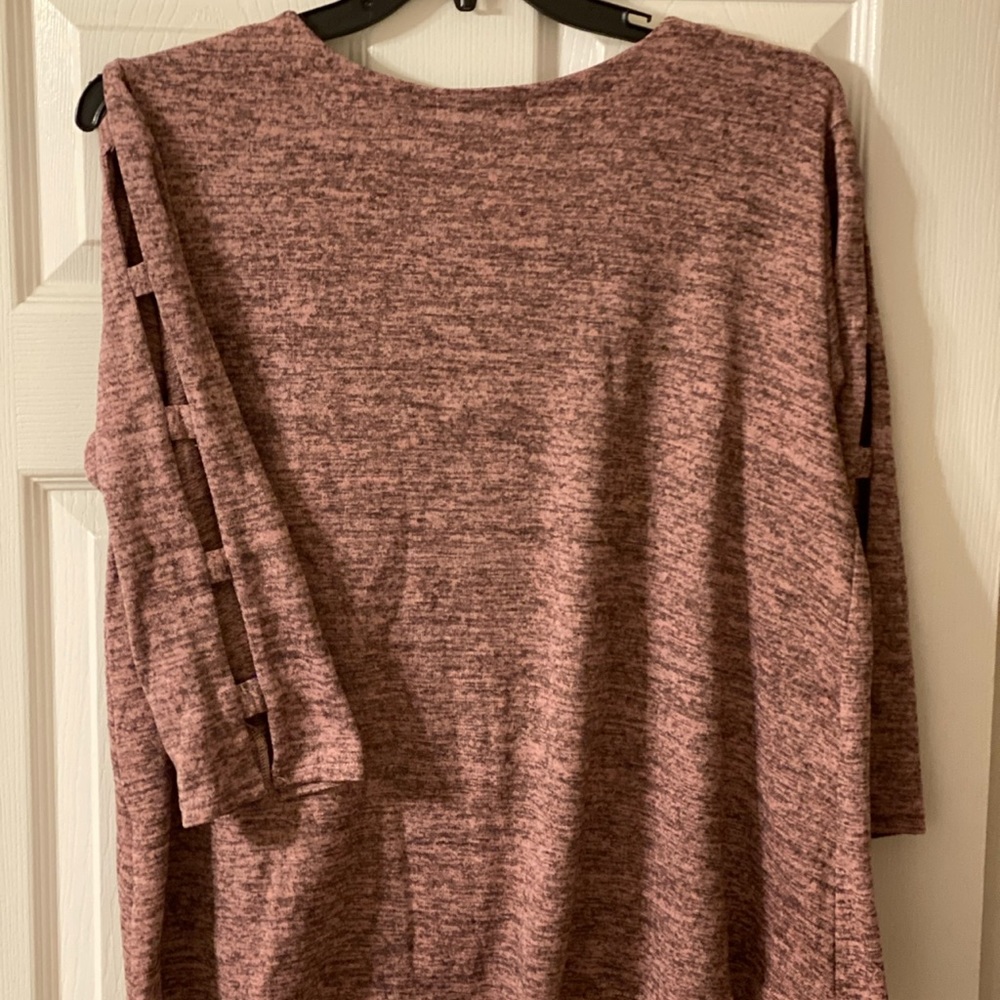 Beautiful pink and black sweater with decorated sleeves.